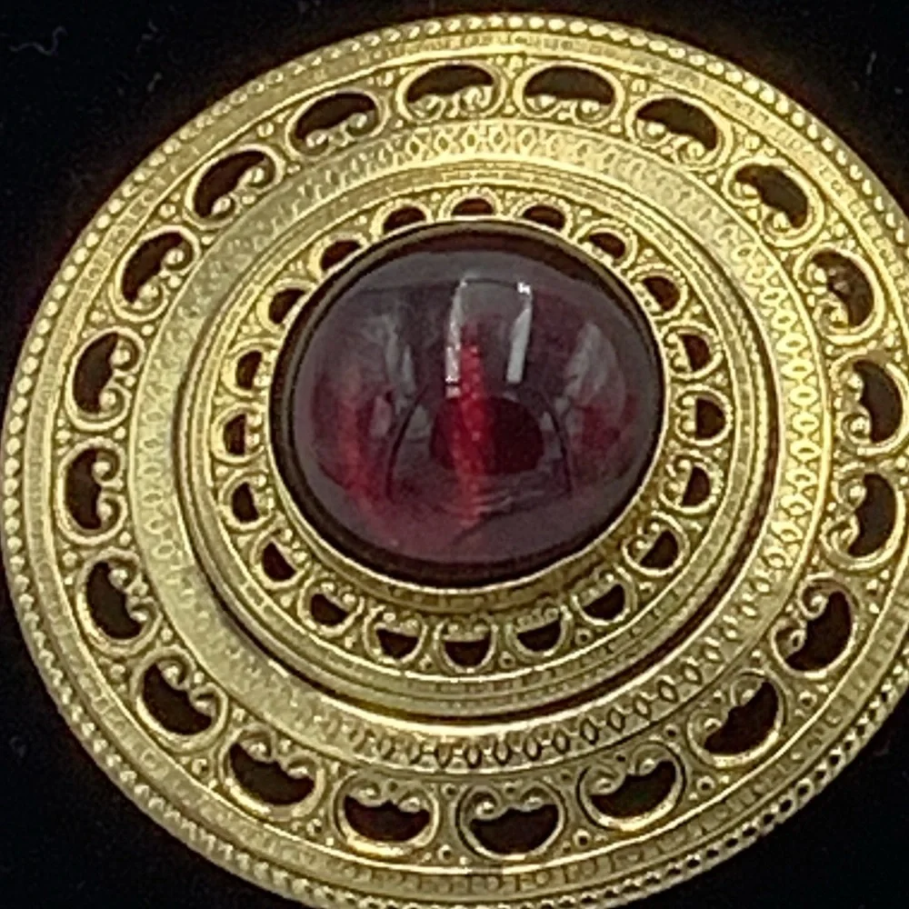 Gold Tone Round Filigree Brooch with Red/Purple Stone